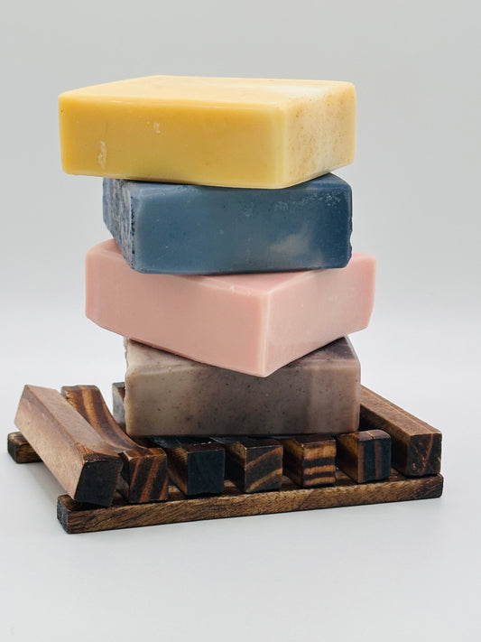 Handmade soap bar drying on a wooden soap dish